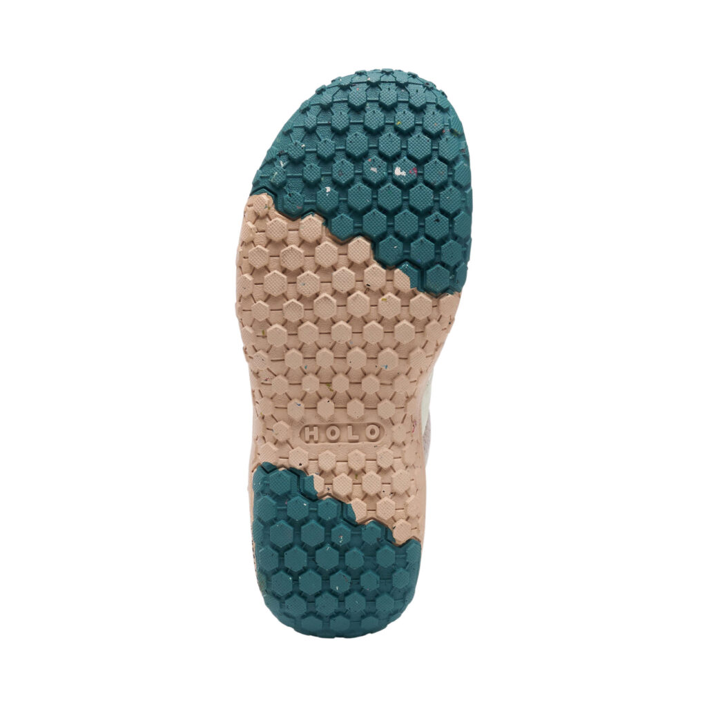 Bottom sole of Cream, pink, and teal slip on shoe