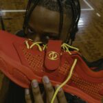 isaac okoro posing with red HOLO IO's