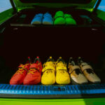 io shoes in a green car's trunk